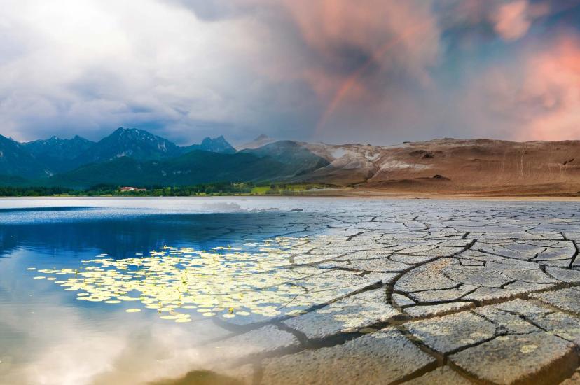 Landscape with mountains and a lake and a dried desert. Global climate change concept