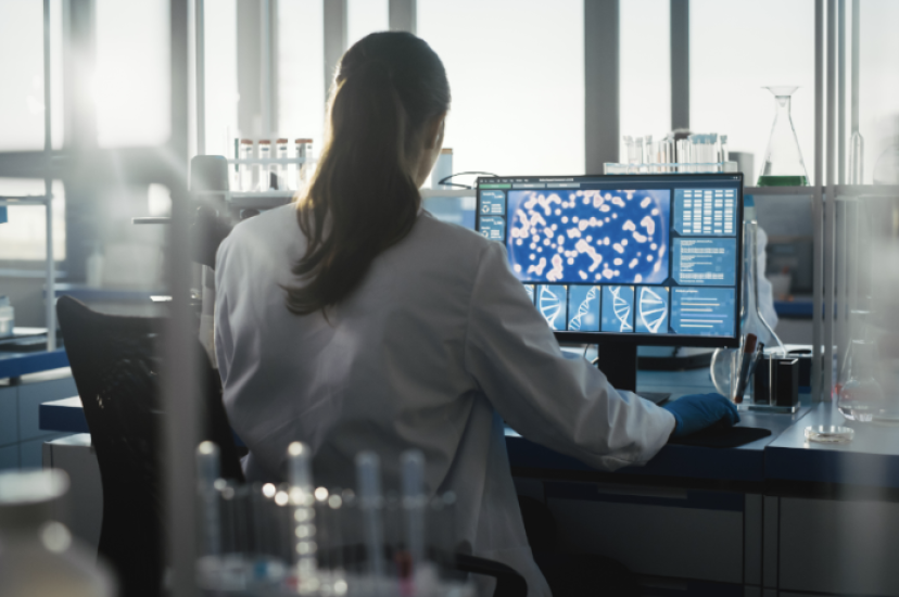 A woman at a computer screen in a lab