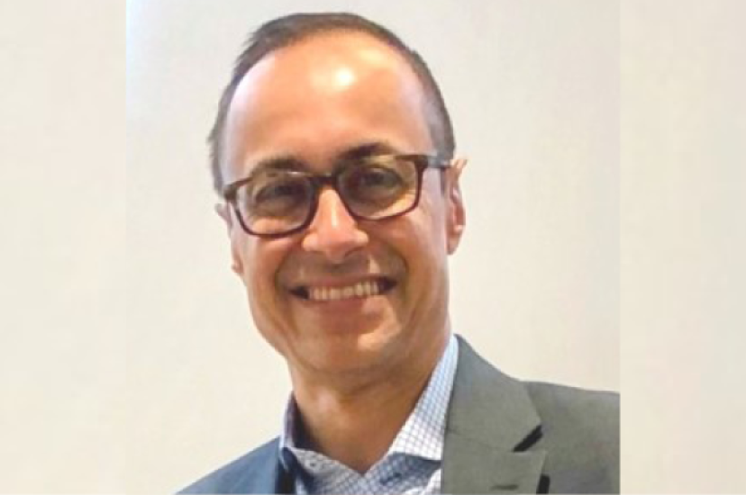A man wearing glasses and a suit