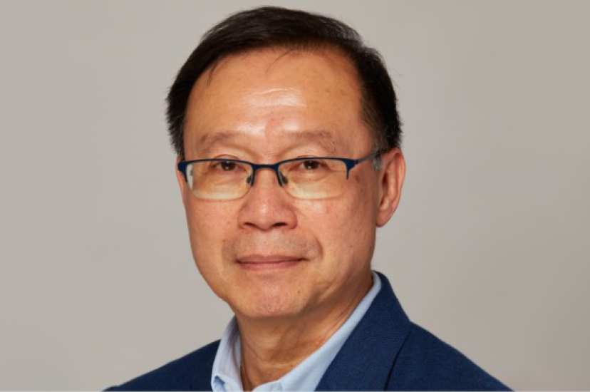 An Asian man with glasses and black hair wearing a blue suit