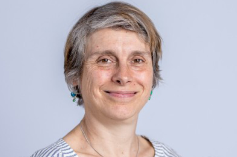 A white woman with short hair and wearing a striped shirt