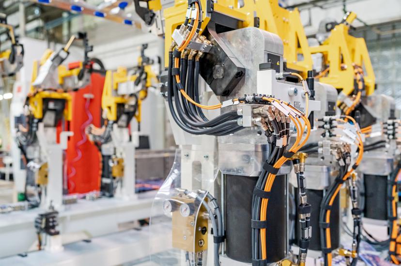 Industrial robot arm operating in automotive manufacturing plant