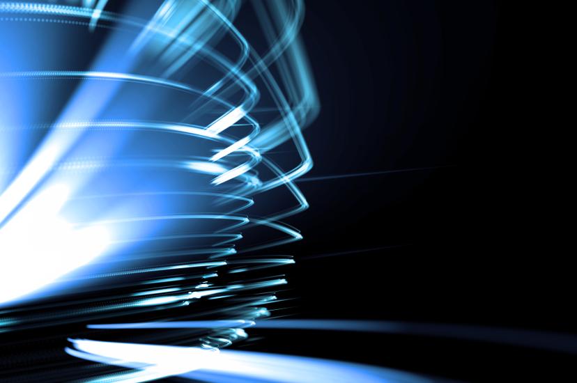 Abstract blue light trails and high-speed data streams against a dark background, symbolising high-performance computing, AI workloads and ultra-fast processing power.