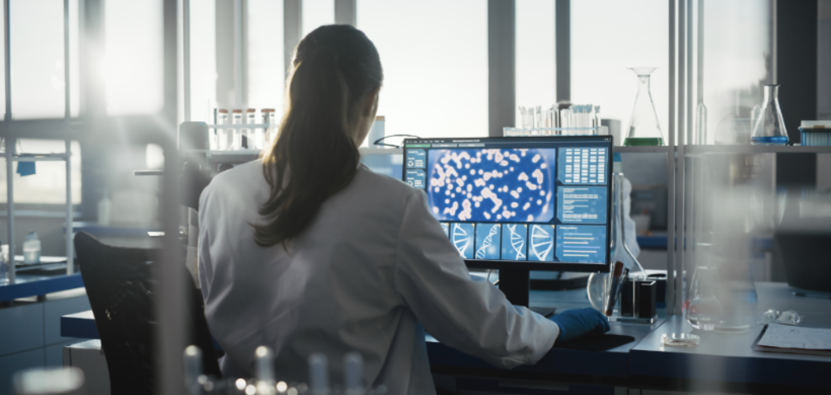 A woman at a computer screen in a lab