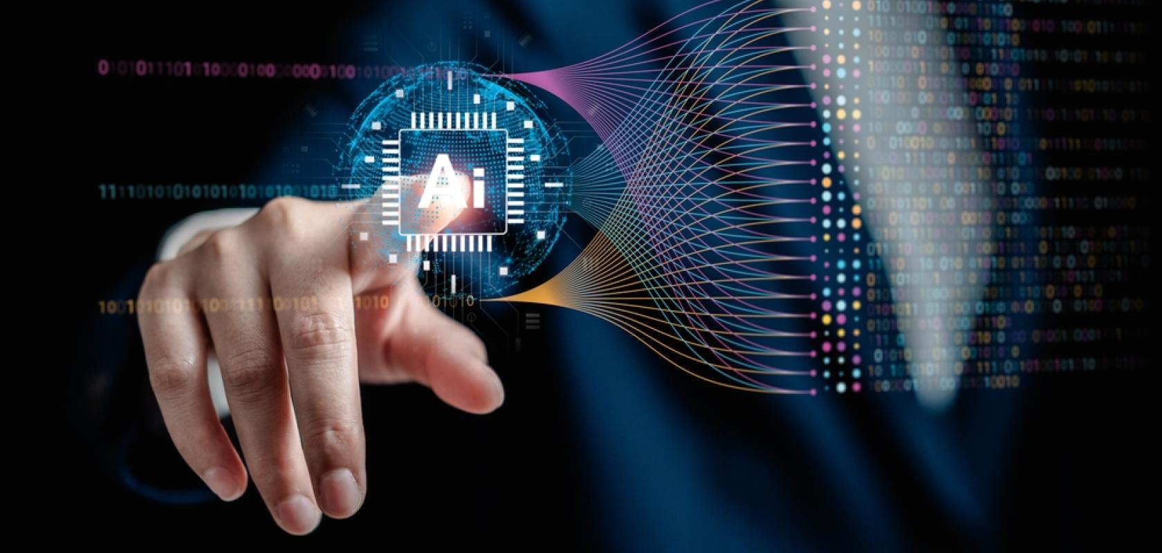 A finger points to the letters 'AI' on a screen.