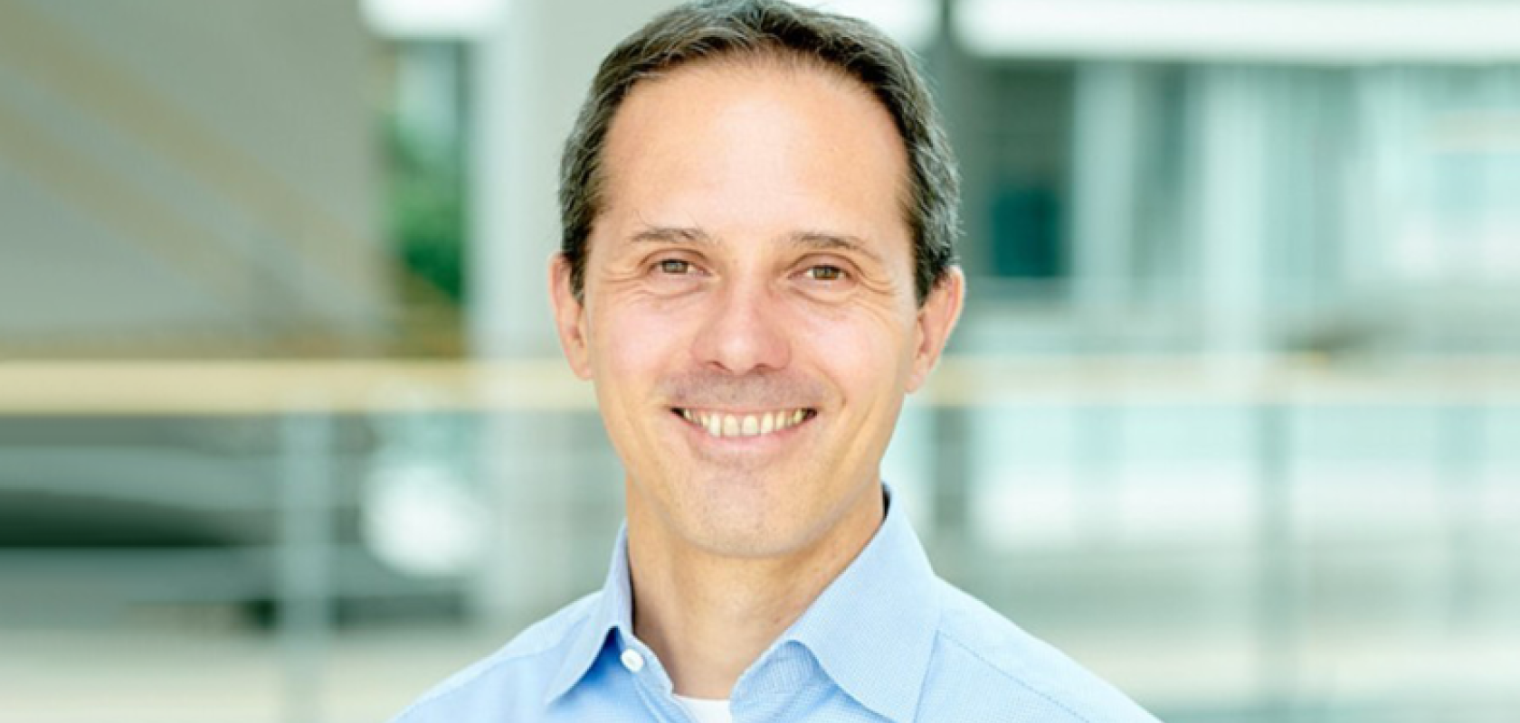 a white man wearing a blue shirt