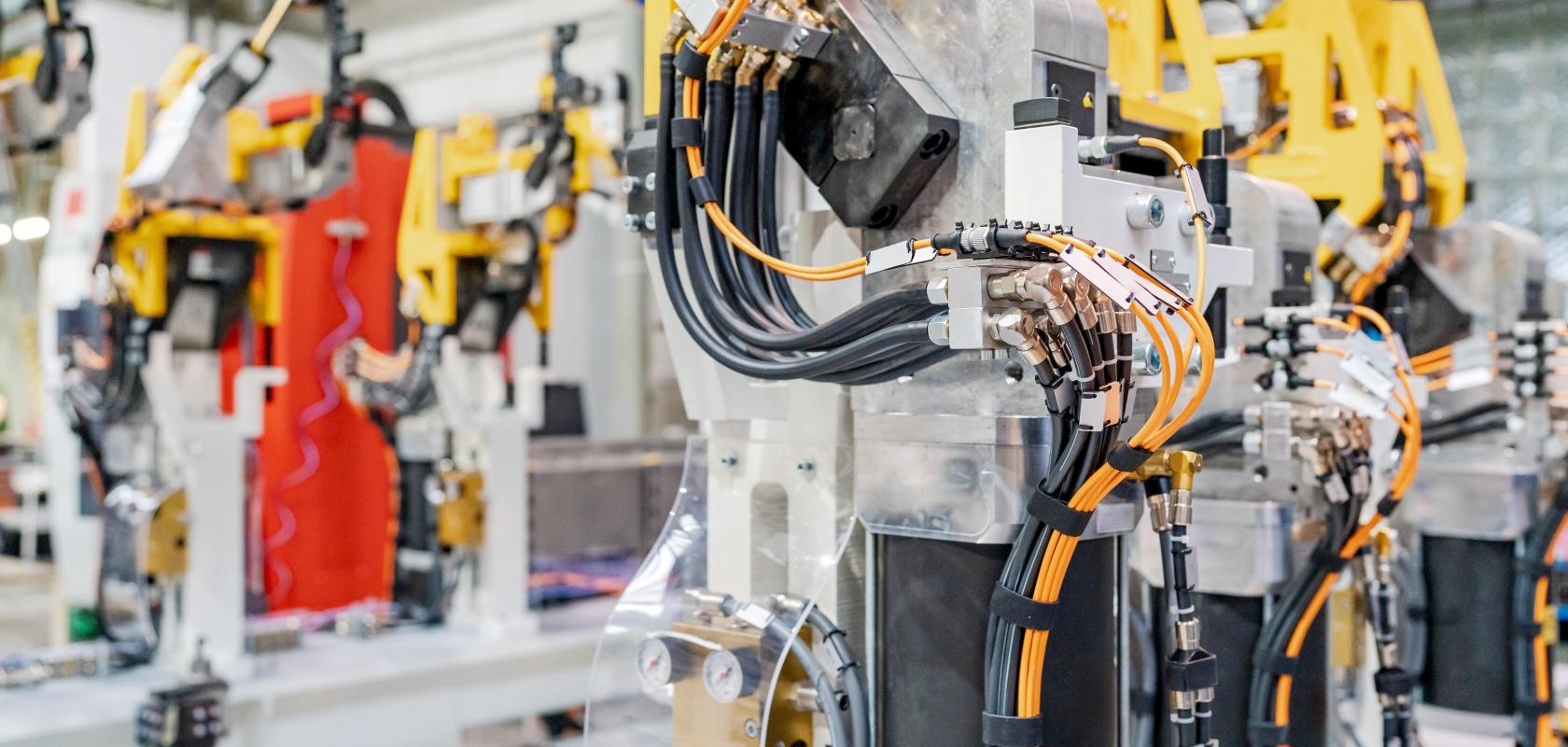 Industrial robot arm operating in automotive manufacturing plant