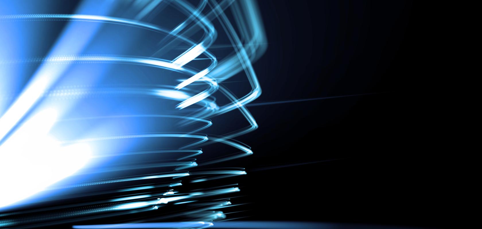 Abstract blue light trails and high-speed data streams against a dark background, symbolising high-performance computing, AI workloads and ultra-fast processing power.